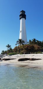 a white lighthouse on a beach,Key Biscayne