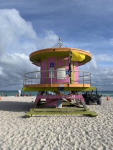 a pink lifeguard tower on a Miami beach